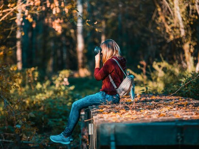 A woman taking photographs in the woods. You can relax and unwind your mind