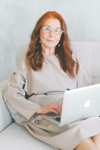 Woman gazes outwards while writing