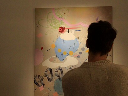 A painting being admired by a fan of  Silia Ka Tung at the Saraceno Art Gallery in Rome