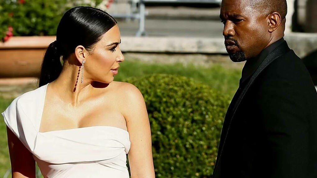 Kim Kardashian and Kanye West in a garden having a minor disagreement