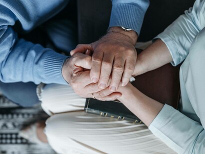 Hands pressed on hands in an attempt to ease the pain experienced by a near-death situation