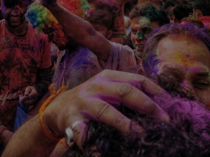 Men celebrating with paint celebrating their culture at a festival in Pakistan
