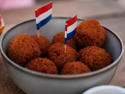 A bowl of bitterballen with a small Dutch flag proudly placed on top