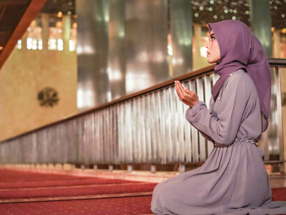 A moment of prayer by a young woman in a Jakarta mosque, Indonesia