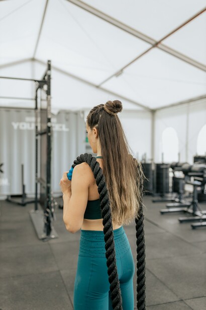 Woman working out with ropes 