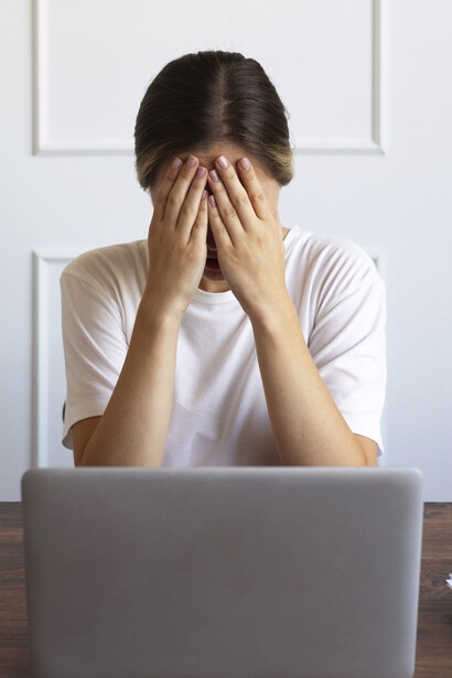 Office worker seated at her desk, visibly tired from long hours of sitting