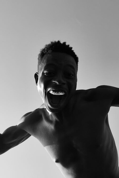 Topless man shouting in anger, yearning for love and acceptance that he cannot give to himself