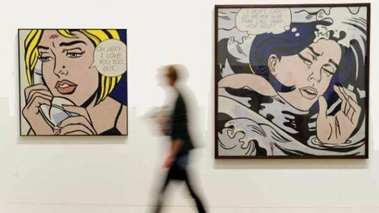 A woman passes Roy Lichtenstein's paintings Oh,Jeff...I Love You, Too...But... 1964, and Drowning Girl, 1963