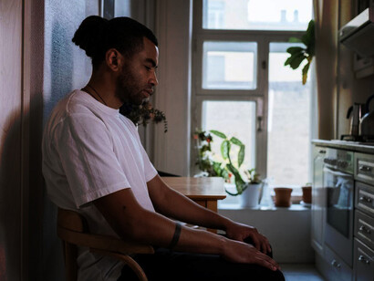 A man with OCD in the kitchen, visibly anxious as he grapples with intrusive thoughts and compulsive rituals
