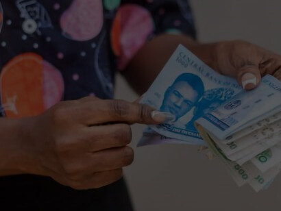 A photograph illustrating a woman proudly holding African currency notes symbolizes her success in business, the prosperity of the continent, and the abundant natural resources that Africa possesses