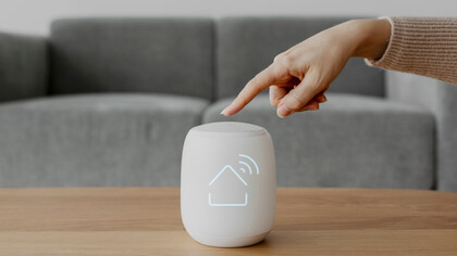 A fingertip activates a smart home hub — symbolizing the connectivity and control of IoT innovation 