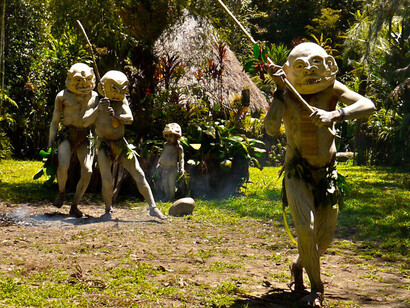 In a haunting tableau, Asaro Mudmen strike battle poses, their ghostly masks telling stories of ancient victories and ancestral spirits