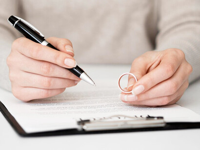 A lonely man contemplating whether to sign the divorce papers, lost in deep thought