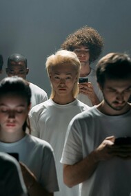A group of people sharing the same space but removed from each other