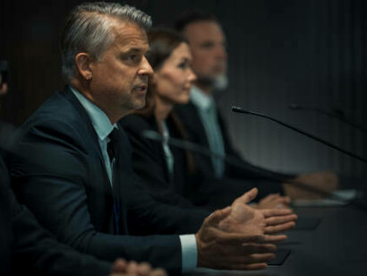 A representative from the organization addressing the conference at a government venue, emphasizing economic diplomacy and strategic partnerships