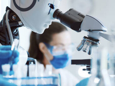 Woman working with an android robot in a science laboratory