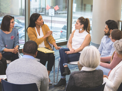 People from diverse cultural backgrounds engaging in meaningful conversation