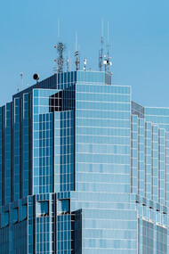 Bathed in sunlight against a brilliant blue sky, this modern architectural marvel illustrates how AI-driven design can create unique, sustainable structures for the future