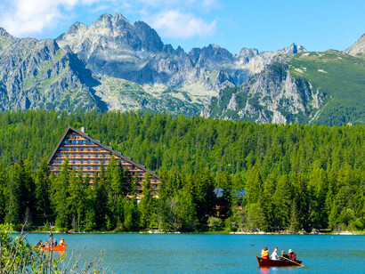 A lakefront resort with mountains in the background at Štrbské Pleso in the High Tatras, Slovakia