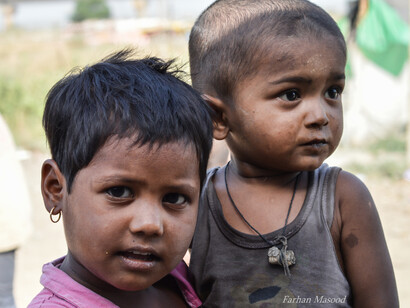 A Rohingya girl carrying her brother
