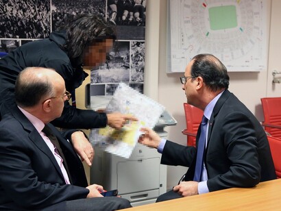 France’s interior minister, Bernard Cazeneuve (left), and the country’s president, François Hollande (right) attend an emergency meeting in the security control room at the Stade de France. Photograph: Christelle Alix/AFP/Getty Images