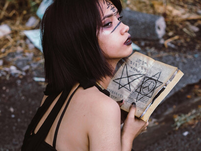 A witch on the forest, reading from her spellbook