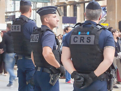 Police officer and two CRS in Gare du Nord, Paris, France