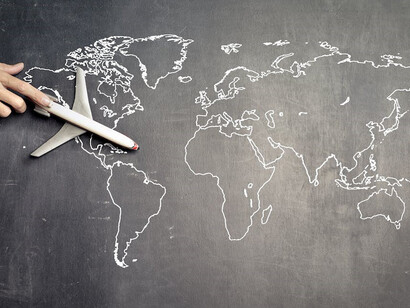 Airplane on world map on blackboard