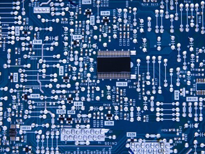 An intricate circuit pathways on a microchip, representing the technological foundations of the digital economy