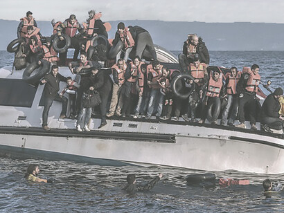 Syrian and Iraq refugees arrive from Turkey to Skala Sykamias, Lesvos island, Greece. Spanish volunteers (life rescue team - with yellow-red clothes) from "Proactiva open arms" 