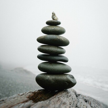 Balanced stones represent different factors required to achieve harmony and well-being