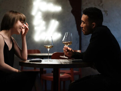 A couple sharing a glass of wine during a romantic evening out