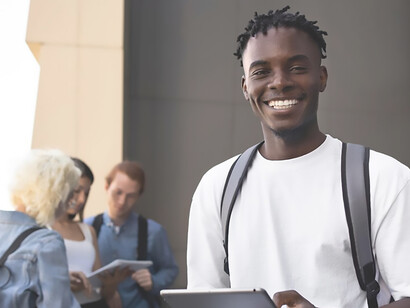 Within the school premises, a young African American student is portrayed, actively engaging in educational activities, showcasing the diversity and vibrancy