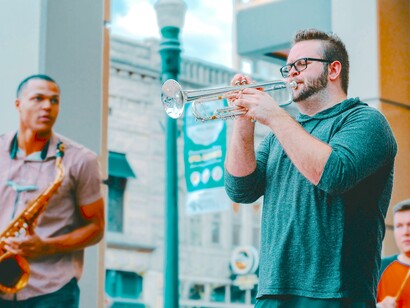 Trumpetista de jazz toca com sua banda nas ruas