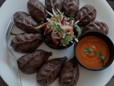 Kodho Momo, a special variety made with buckwheat (known as kodho), which grows in the highlands of Nepal. While momo is traditionally prepared with regular flour, this version combines two unique elements: the classic Newari dumpling and the earthy flavor of buckwheat