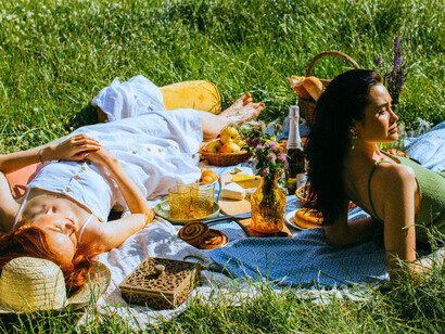 Friends resting on a picnic blanket, reclaiming connection without digital interruption