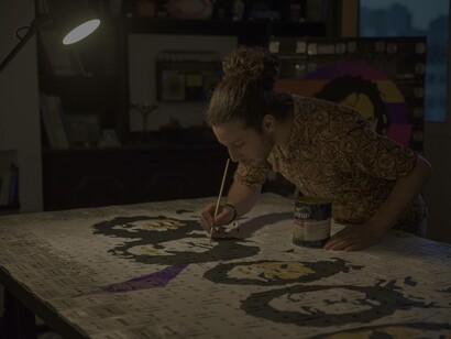 Youness Miloudi carefully painting a very intriguing piece of art photo by Karim Tajouaout