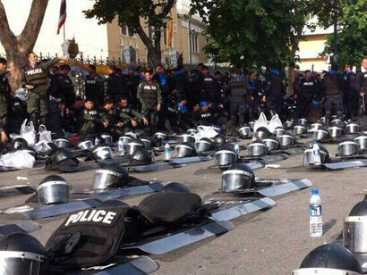 Riot police in Thailand put down their helmets and shields in solidarity with nonviolent activists campaigning for the removal of the corrupt Shinawatra government, 6 December 2013