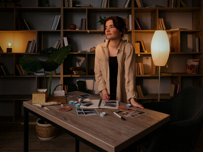 A woman lingering beside her worktable in silence, representing the loneliness hidden within artistic pursuit