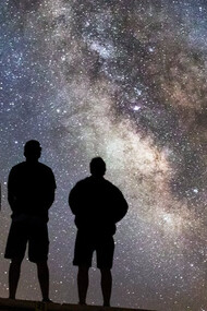 Beneath a blanket of stars, a group gazes skyward, finding solace in the vastness of the cosmos, where individual plans fade into the brilliance of universal mysteries