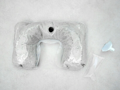 Rowena Harris, The fundamental ergonomics of body meets machine, 2015, neck cushion inflated with concrete, cast silicon rubber, sealed plastic containing one breath, 56 x 30 x 9 cm