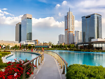 Reflections of contemporary buildings in a pool at Tashkent City Park, Uzbekistan