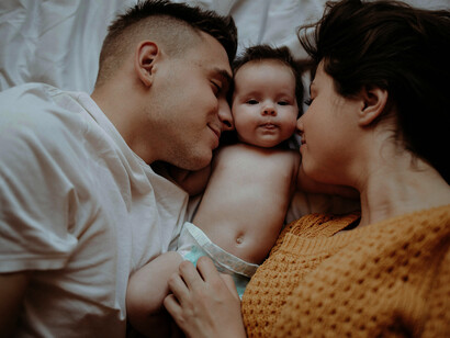 A loving family spends time together with their baby, celebrating connection, happiness, and togetherness in a cozy home setting