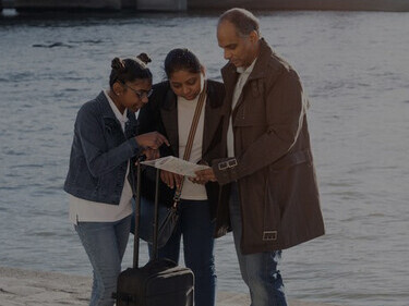 Expats with a map searching for directions in their new city, reflecting their journey and adaptation to a new environment