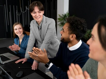 A team member engaging with colleagues in the office, showcasing how diverse personality types contribute to successful collaboration and teamwork