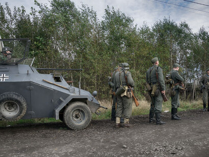 A group of soldiers in uniform, holding guns in their hands