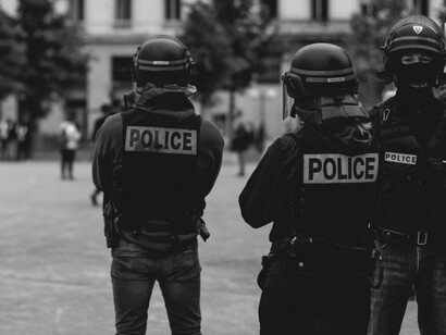 Grayscale image showing a group of uniformed police officers