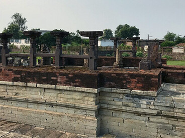 The ruins of the Baleshwar Shiva Temple reveal the foundations of multiple ancient shrines and have produced important archaeological findings, including statues of Hindu gods and goddesses, carved reliefs, pillars, temple remains, and Shiva lingas. The site was documented during the archaeological work of Alexander Cunningham