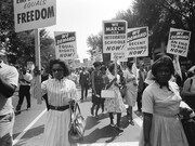 Washington, D.C. August 28, 1963, The civil rights march on Washington with a procession of African Americans carrying signs for equal rights and integrated schools
