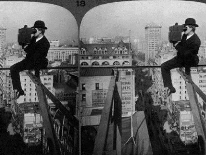 circa 1910: A stereoscope image of a man steadying himself on a thin steel beam suspended high over the streets of Manhattan as he looks up Fifth Avenue, past the Flatiron Building and Madison Square Garden, with his camera, New York City. (Photo by George Eastman House/UndGeorge Eastman House/Underwood & Underwood/Getty Images)
